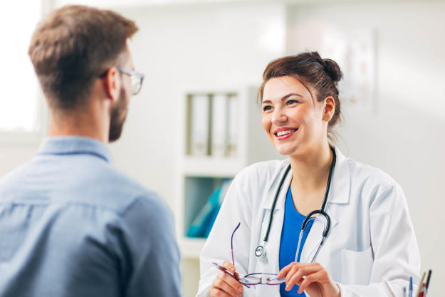What to Expect During Hormone Optimization a doctor teaches a patient what is hormone optimization