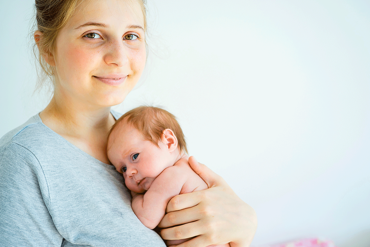 How-Long-Does-It-Take-for-Hormones-to-Balance-After-Birth Woman holds her baby after talking to a friend about how to optimize hormones
