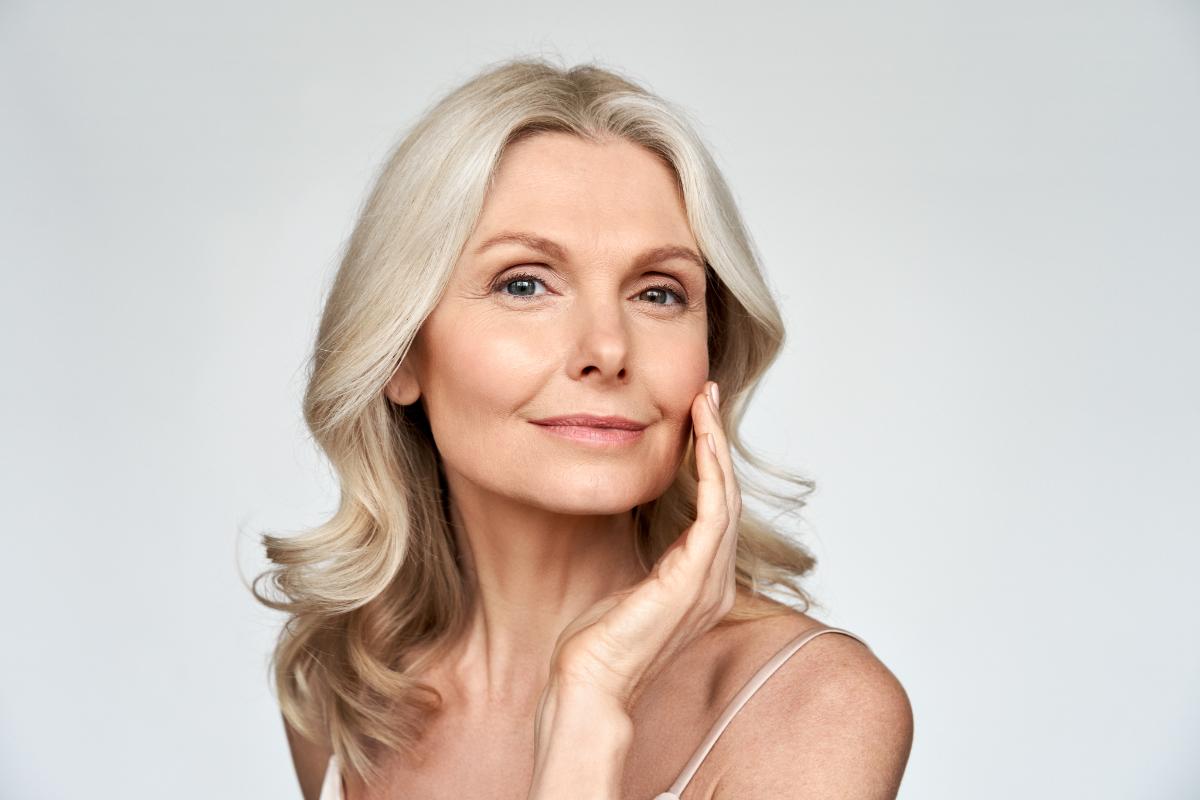 5 Benefits of Botox Woman touches face as she enjoys Botox benefits