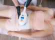 Woman lays down as she undergoes warm sculpting procedure