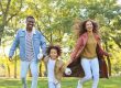 Family walking together outdoors in a park on a sunny day